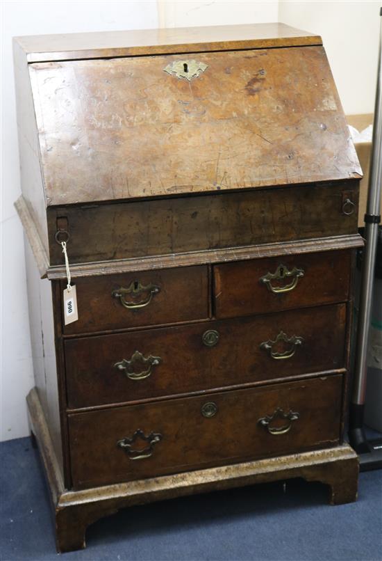 An early 18th century style walnut bureau incorporating older timbers